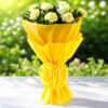 Hand-wrapped yellow carnations bouquet with decorative yellow paper and ribbon - ideal for flower delivery in Guwahati