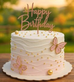 Pink and white butterfly birthday cake with golden pearls, perfect for celebrations in Guwahati