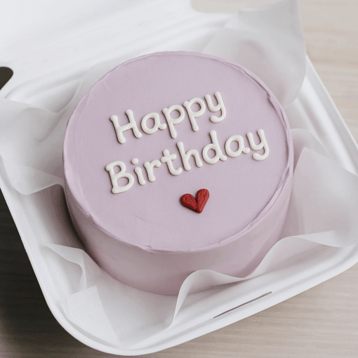 Purple Korean bento cake with white icing text and red heart, perfect for birthday, celebrations, available for delivery in Guwahati.