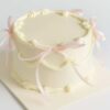 Elegant ribbon cake with pink bows for birthdays and celebrations in Guwahati