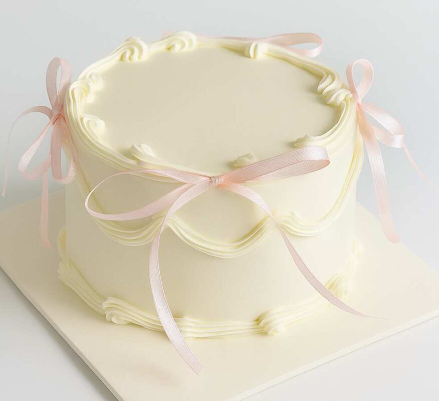 Elegant ribbon cake with pink bows for birthdays and celebrations in Guwahati