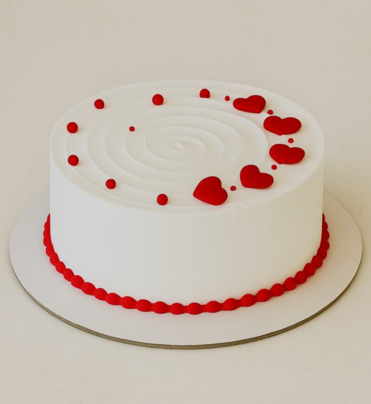 Romantic red hearts cream cake with white frosting, perfect for birthdays and anniversaries in Guwahati – fresh cream and same-day delivery.