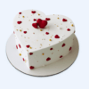 Romantic heart shape cake with red hearts and white cream, perfect for romantic celebrations in Guwahati.