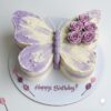 Lavender butterfly theme birthday cake with floral icing and “Happy Birthday” message in Guwahati