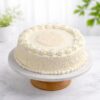 Classic White Forest Cake with fresh whipped cream and white chocolate shavings on marble cake stand delivery in guwahati