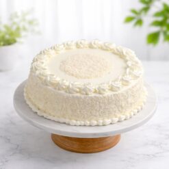Classic White Forest Cake with fresh whipped cream and white chocolate shavings on marble cake stand delivery in guwahati
